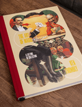 Book titled 'The Art of Magic' by Ken Trombly on a wooden surface
